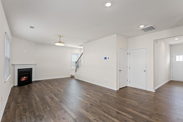 unfurnished living room featuring dark hardwood / wood-style flooring