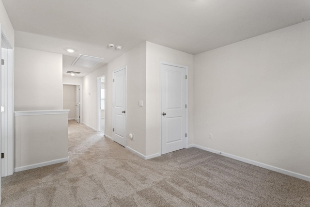 unfurnished room featuring light colored carpet