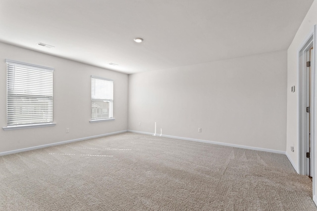 spare room with light carpet