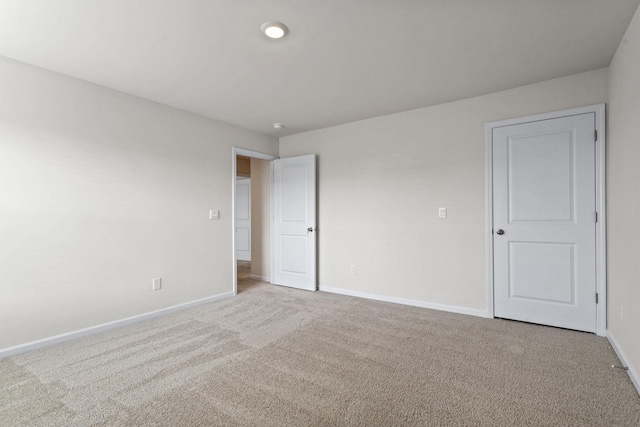 spare room featuring light colored carpet