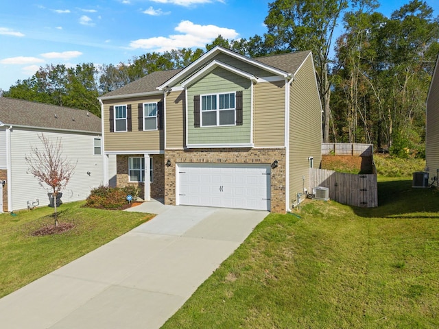 view of front of house with a front yard, central AC, and a garage