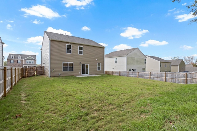 back of property featuring a patio area and a yard