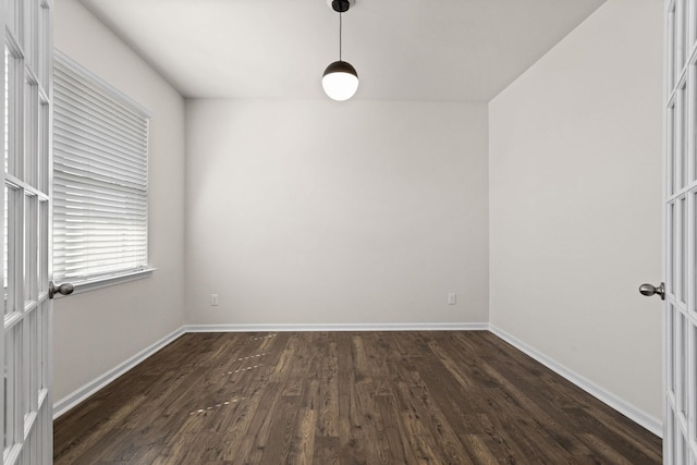 empty room with dark hardwood / wood-style flooring