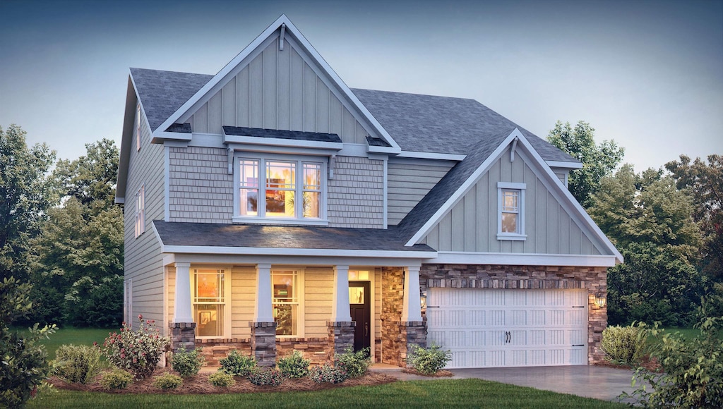 craftsman inspired home with a garage and a porch