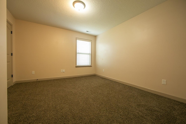 carpeted spare room with a textured ceiling