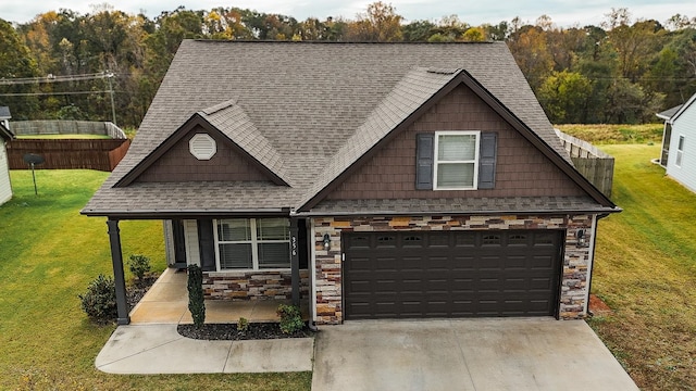 view of front of property with a front yard and a garage