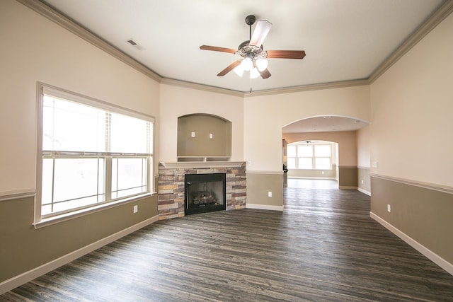 unfurnished living room featuring dark hardwood / wood-style flooring, ornamental molding, and a fireplace