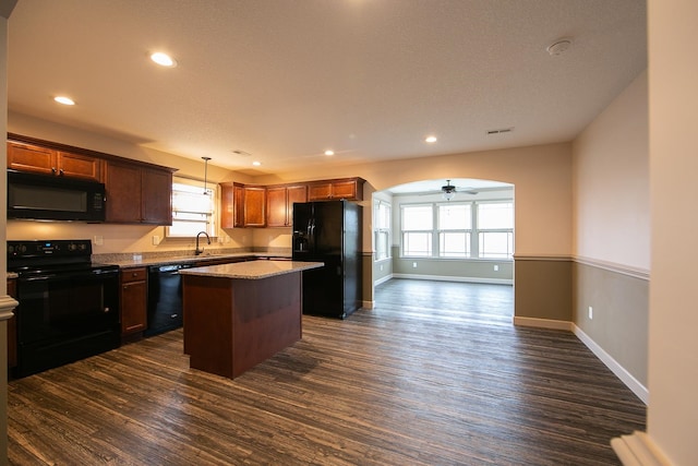 kitchen with black appliances, a wealth of natural light, decorative light fixtures, and ceiling fan