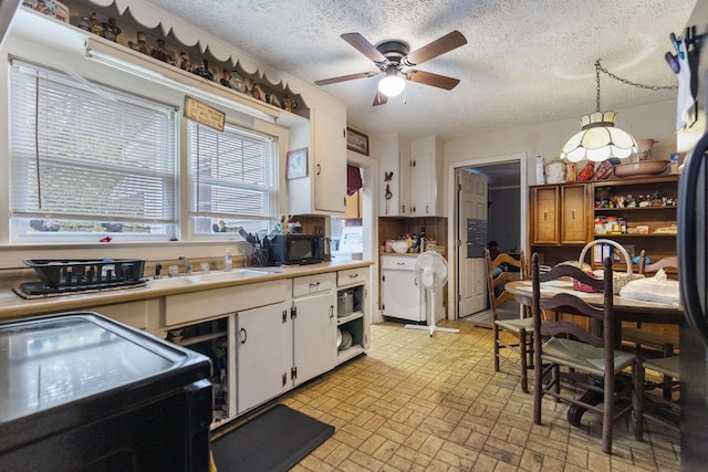 kitchen with white cabinetry, a textured ceiling, range, pendant lighting, and ceiling fan