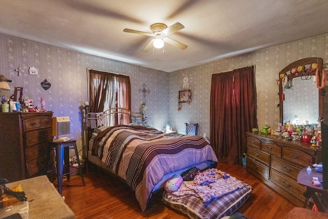 bedroom featuring a wall unit AC, dark wood-type flooring, and ceiling fan