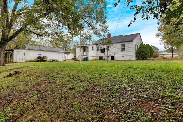 rear view of property with a lawn