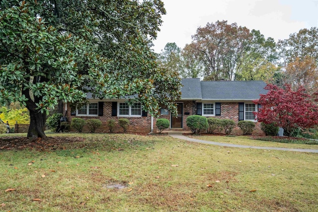 ranch-style home featuring a front yard