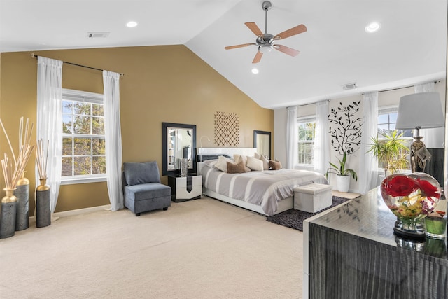 bedroom with carpet flooring, multiple windows, and vaulted ceiling