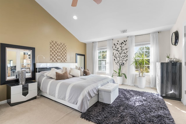 bedroom with multiple windows, light carpet, ceiling fan, and high vaulted ceiling