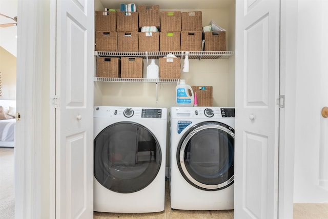 clothes washing area featuring washing machine and dryer and light carpet