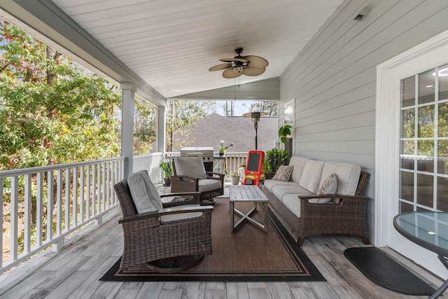 wooden deck featuring ceiling fan and an outdoor living space