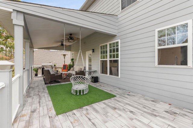 view of patio / terrace with a deck, ceiling fan, and outdoor lounge area