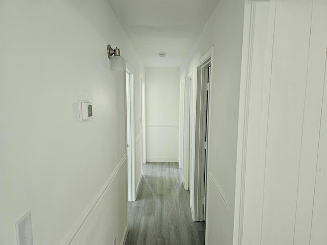 corridor with light hardwood / wood-style floors