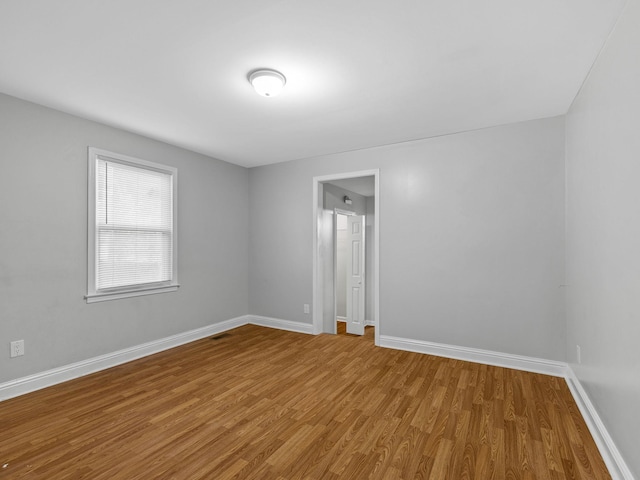 unfurnished room featuring wood-type flooring