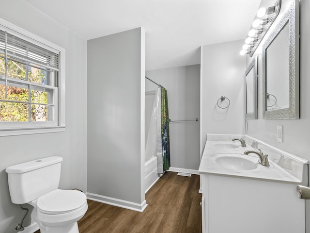 bathroom featuring wood-type flooring, vanity, and toilet