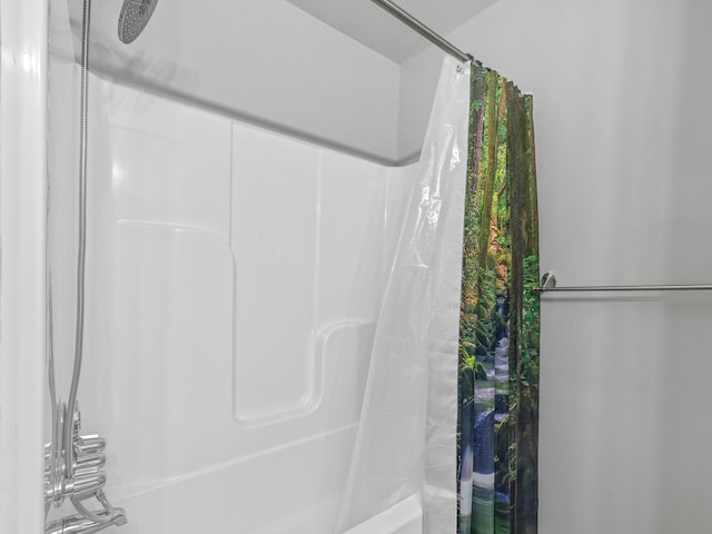 bathroom with shower / bath combination with curtain