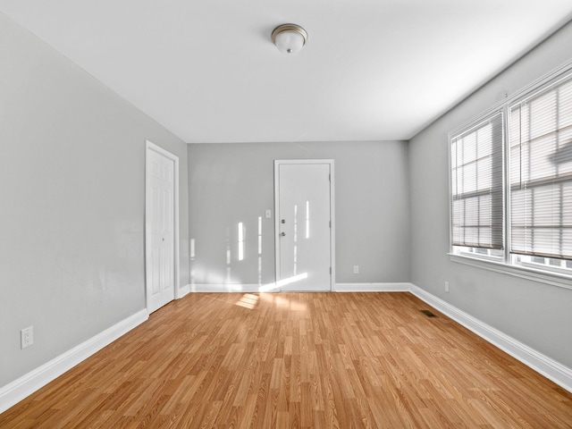 empty room with light hardwood / wood-style floors