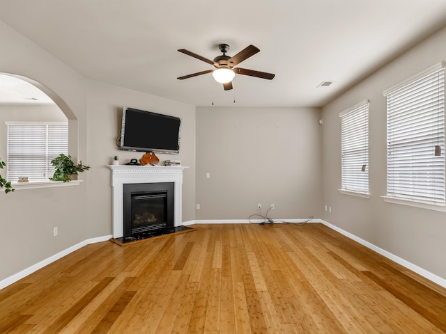 unfurnished living room featuring hardwood / wood-style floors and ceiling fan