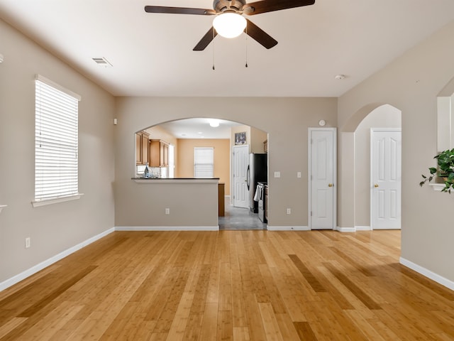 unfurnished living room featuring light hardwood / wood-style floors and ceiling fan