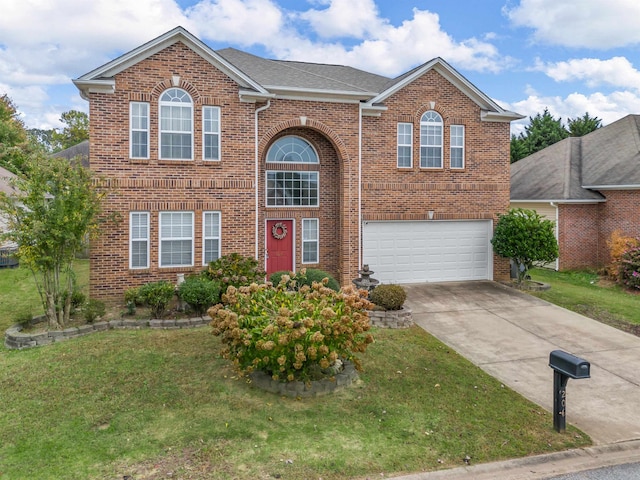 view of front of home featuring a garage and a front yard