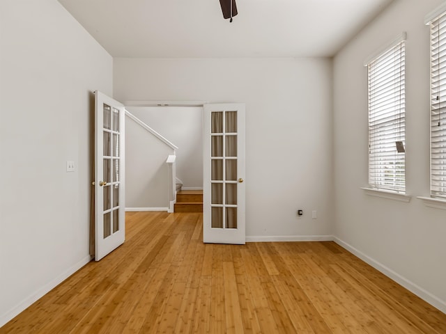 unfurnished room featuring a healthy amount of sunlight, light wood-type flooring, and french doors