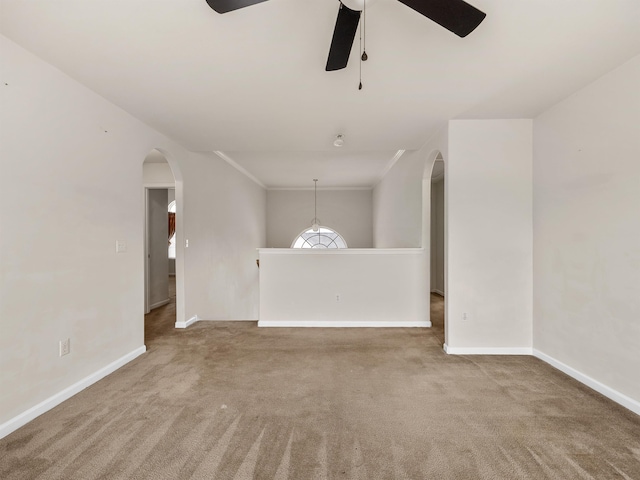 carpeted spare room featuring ceiling fan