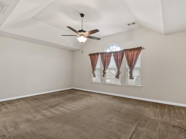 carpeted spare room featuring ceiling fan and lofted ceiling