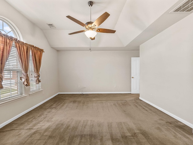 carpeted empty room with ceiling fan and vaulted ceiling