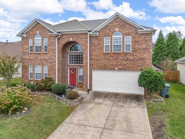 view of front property featuring a garage and a front yard