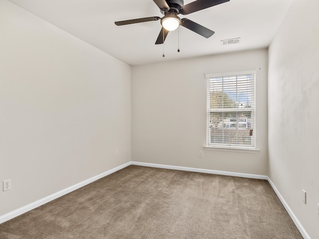 empty room with carpet flooring and ceiling fan