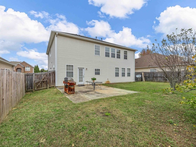 rear view of house featuring a patio and a yard