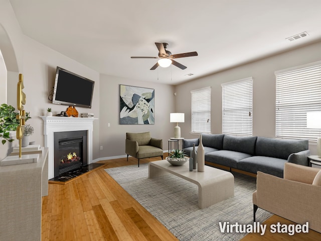 living room featuring hardwood / wood-style flooring and ceiling fan