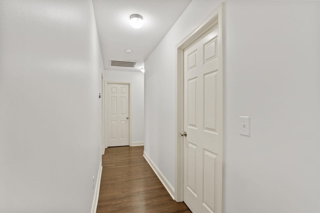 hall with dark hardwood / wood-style flooring