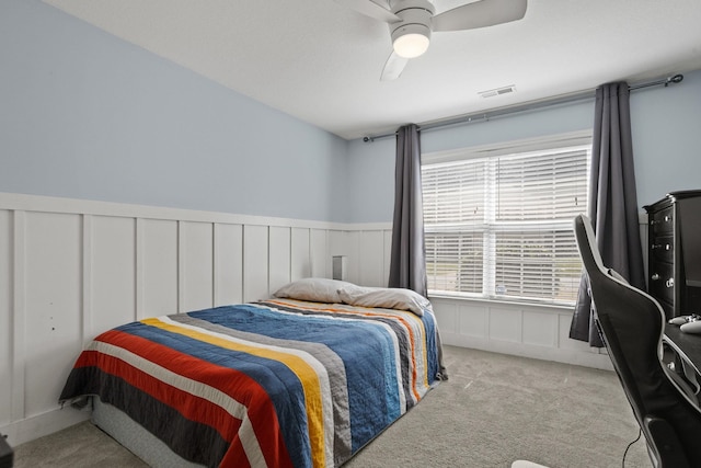 bedroom featuring light colored carpet and ceiling fan