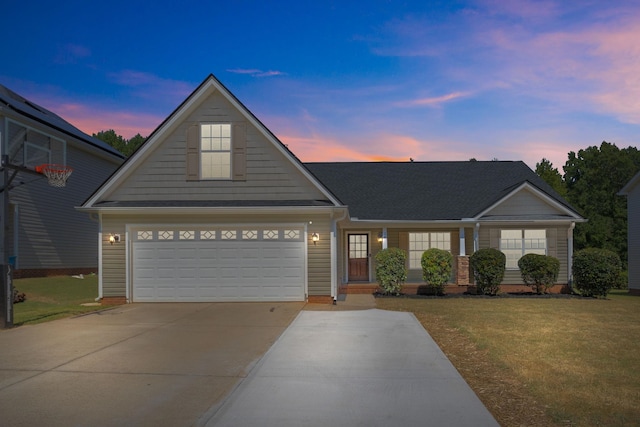 view of front facade with a garage and a yard