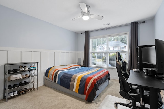 bedroom featuring ceiling fan and light carpet