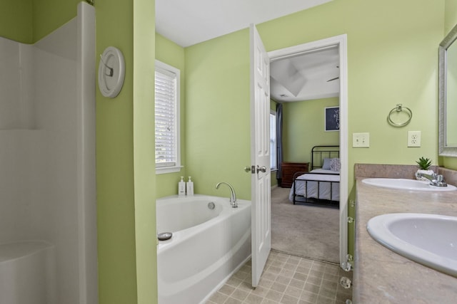 bathroom with vanity and a tub