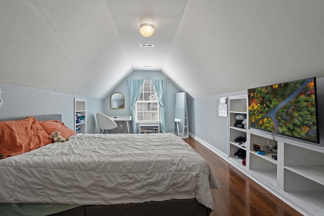 bedroom with dark hardwood / wood-style flooring and vaulted ceiling