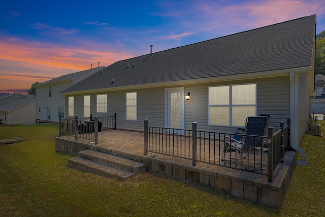 back house at dusk with a yard and a patio area