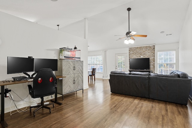 living room with a wealth of natural light, ceiling fan, lofted ceiling, and hardwood / wood-style flooring