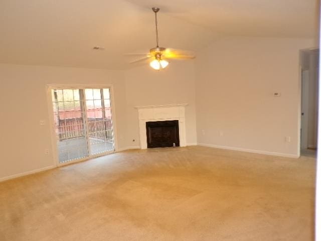 unfurnished living room with ceiling fan, lofted ceiling, and carpet floors