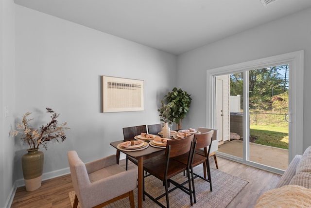 dining space with light hardwood / wood-style floors