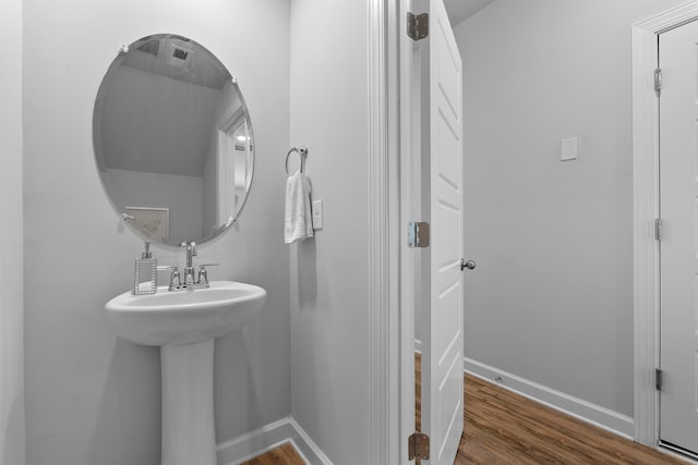 bathroom with hardwood / wood-style floors