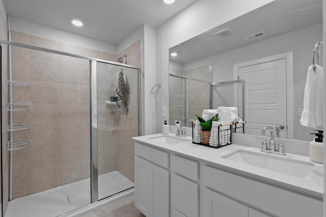 bathroom with vanity, tile patterned floors, and a shower with shower door