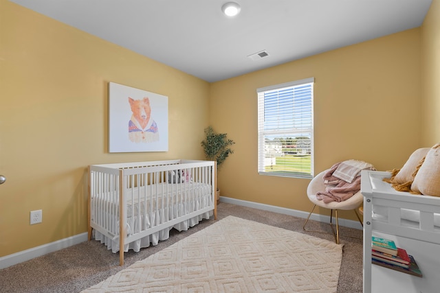 carpeted bedroom with a crib